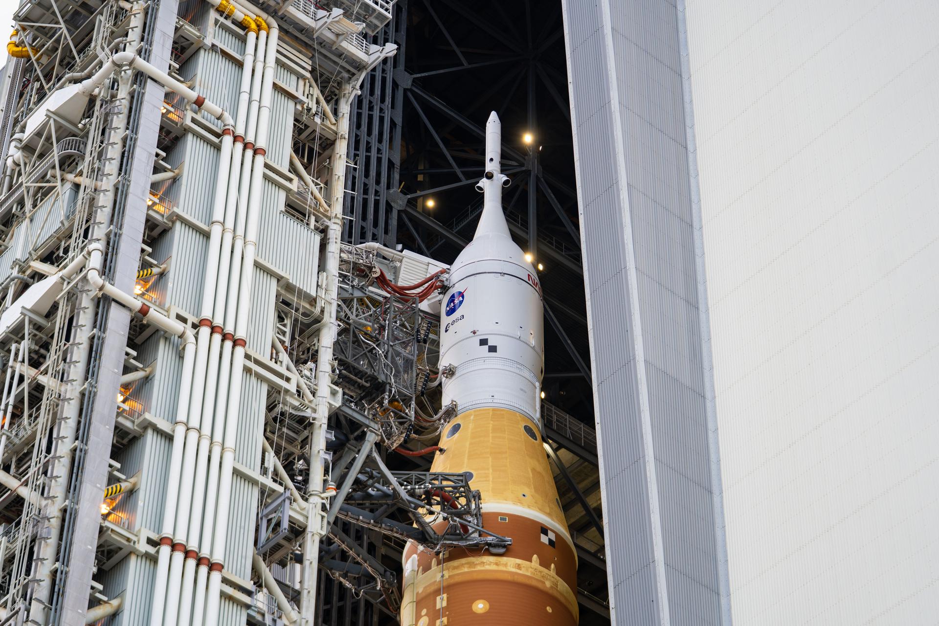 This image shows NASA’s SLS (Space Launch System) and Orion spacecraft rolling out of the Vehicle Assembly Building at NASA’s Kennedy Space Center. NASA's massive Crawler-Transporter, upgraded for the Artemis program, carries the powerful SLS rocket and Orion spacecraft on the Mobile Launcher from the Vehicle Assembly Building to Launch Pad 39B at Kennedy Space Center in preparation for the Artemis II mission.